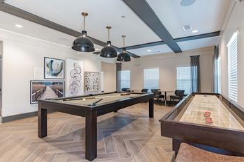 Game room equipped with shuffle board, pool tables & arcade games